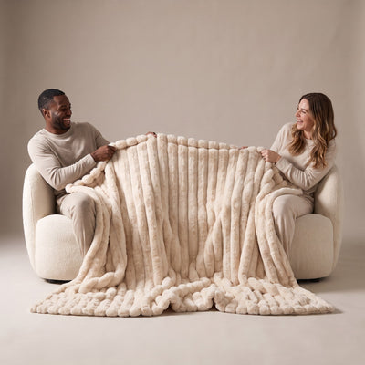 two people stretching the blanket to show its width