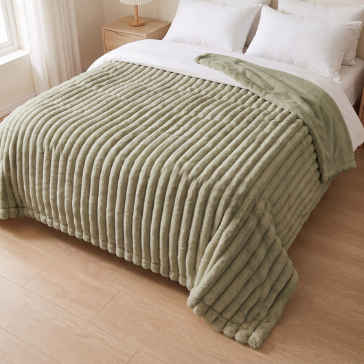 sage blanket on a bed